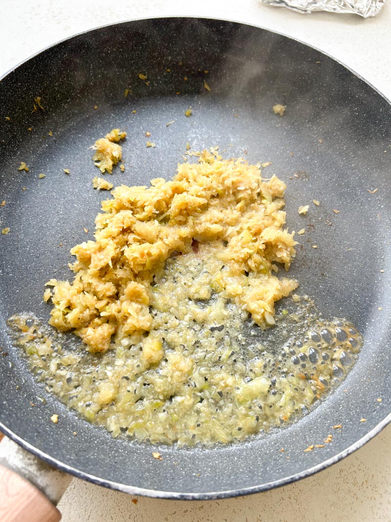 White wine poured in the skillet with the minced garlic and onion.