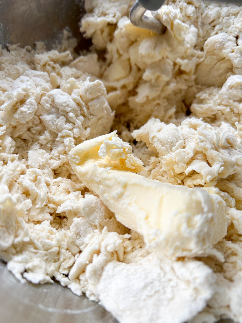 Butter added to the dough, in the stand mixer's bowl.
