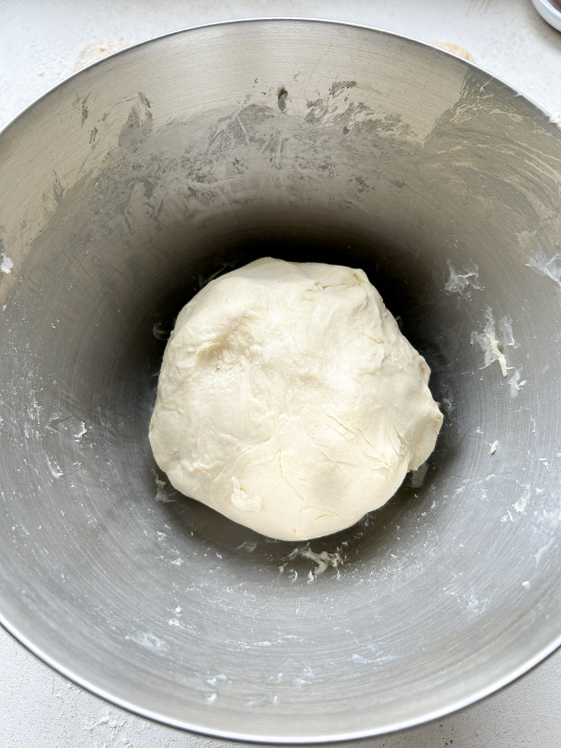 The dough ball back into the stand mixer's bowl, before its first rise.