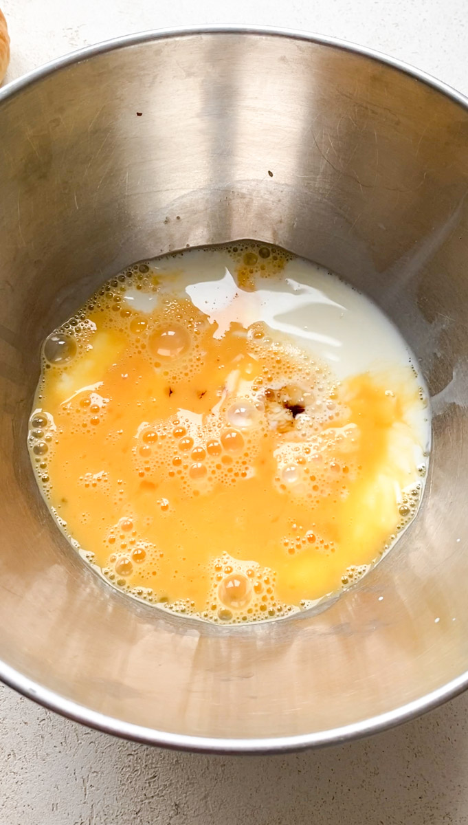 Vanilla extract added to the bowl of eggs and milk.