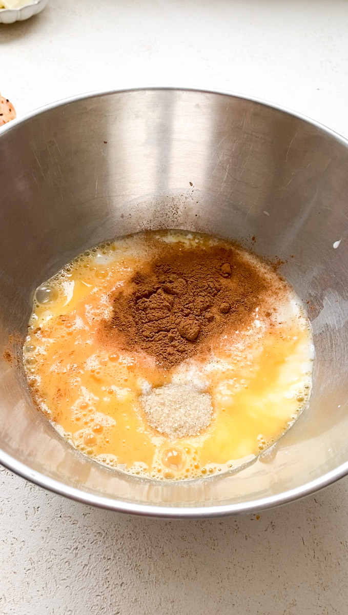 Brown sugar added to the bowl of milk and eggs.