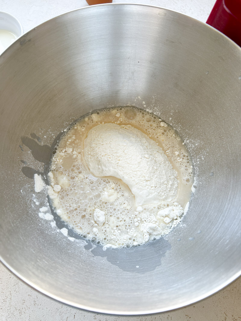 Flour and water mixture combined in the stand mixer's bowl.