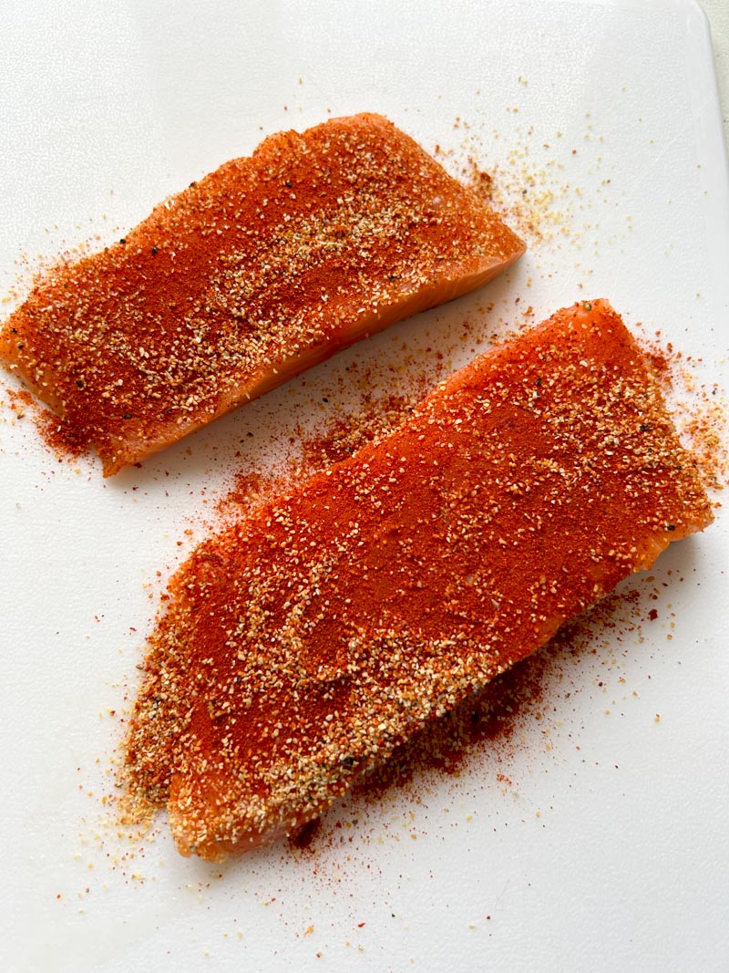 Salmon fillets perfectly coated with seasoning.