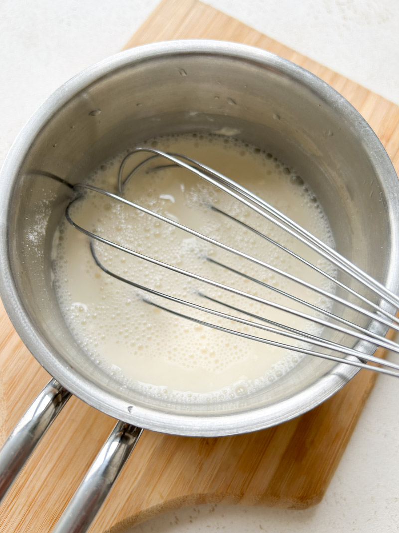 A whisk whisking the flour and water mixture, to prepare the Tangzhong.