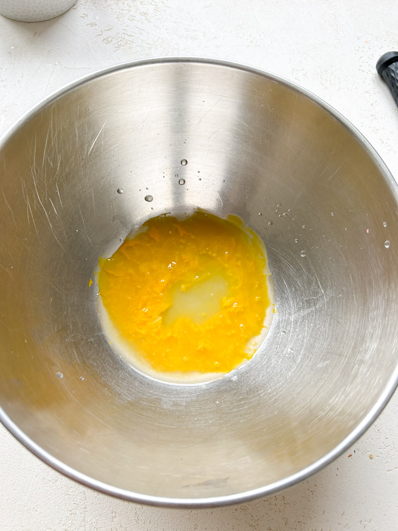 Sparkling water added to the egg yolk's bowl.