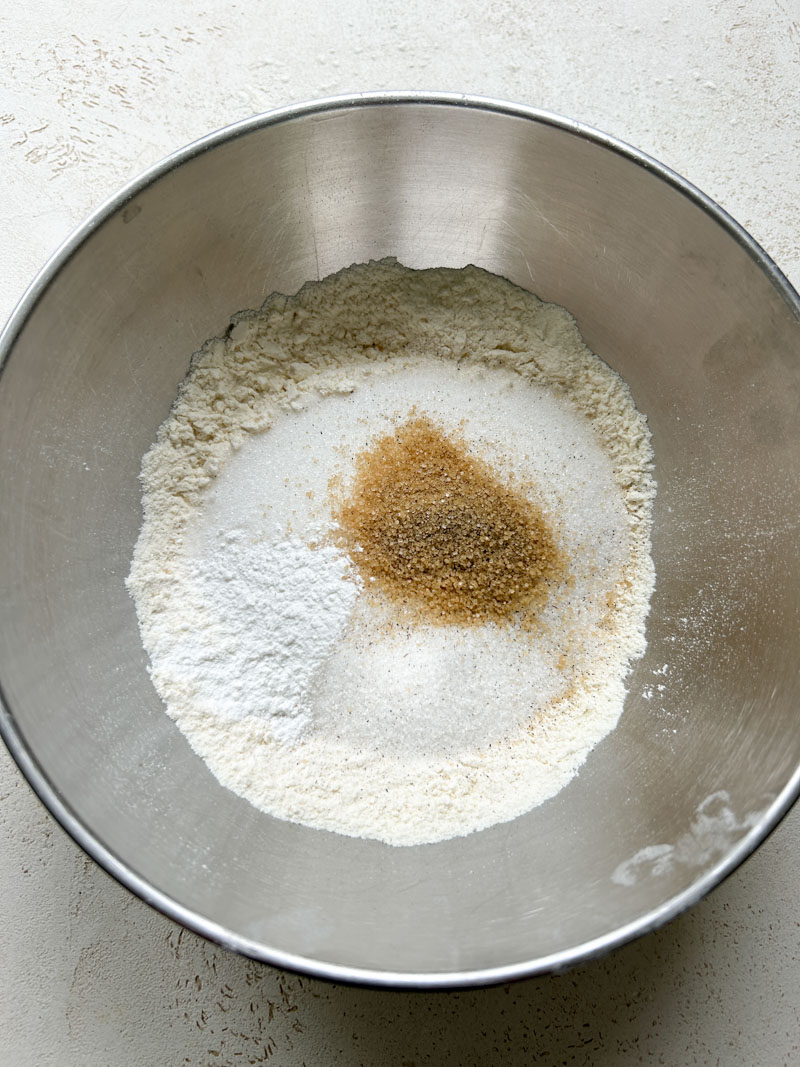 Flour, yeast, sugar and vanilla sugar in a stainless steel bowl.