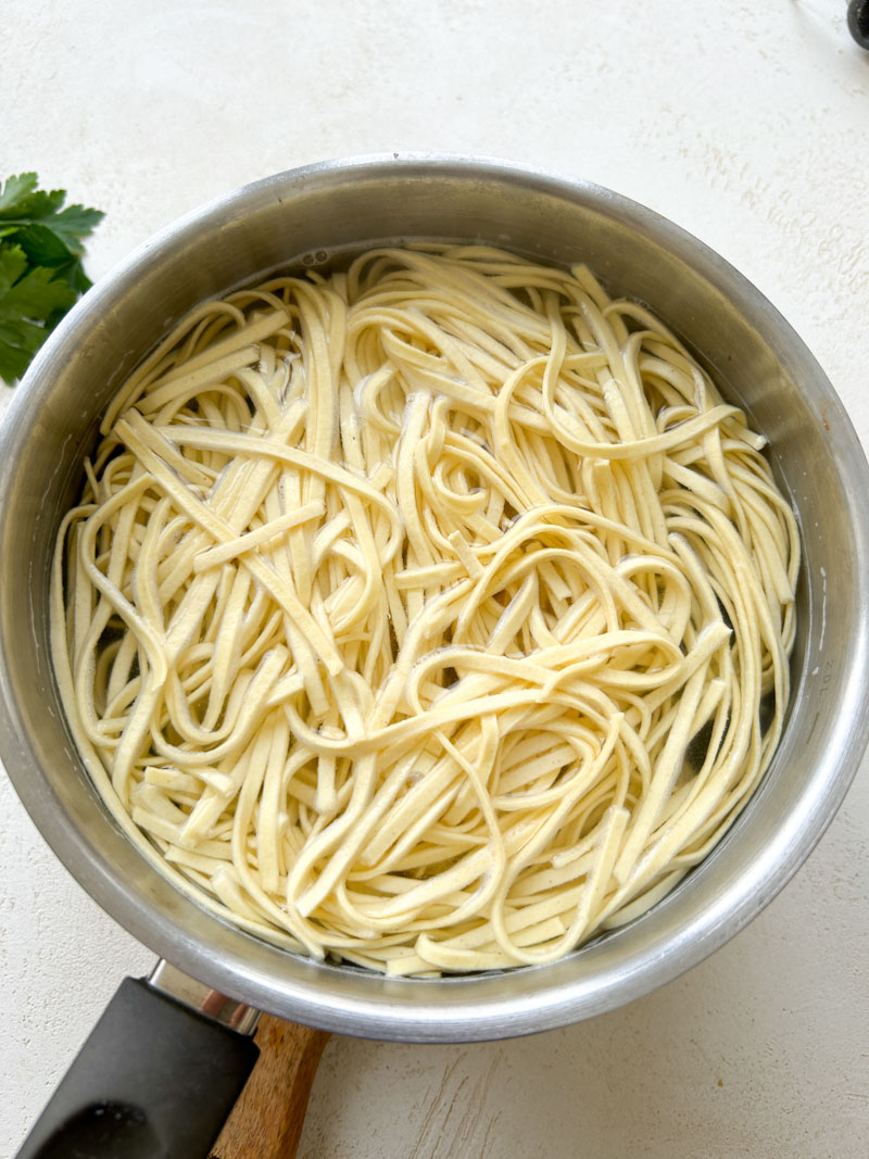 Pasta cooking in a large pot of water.