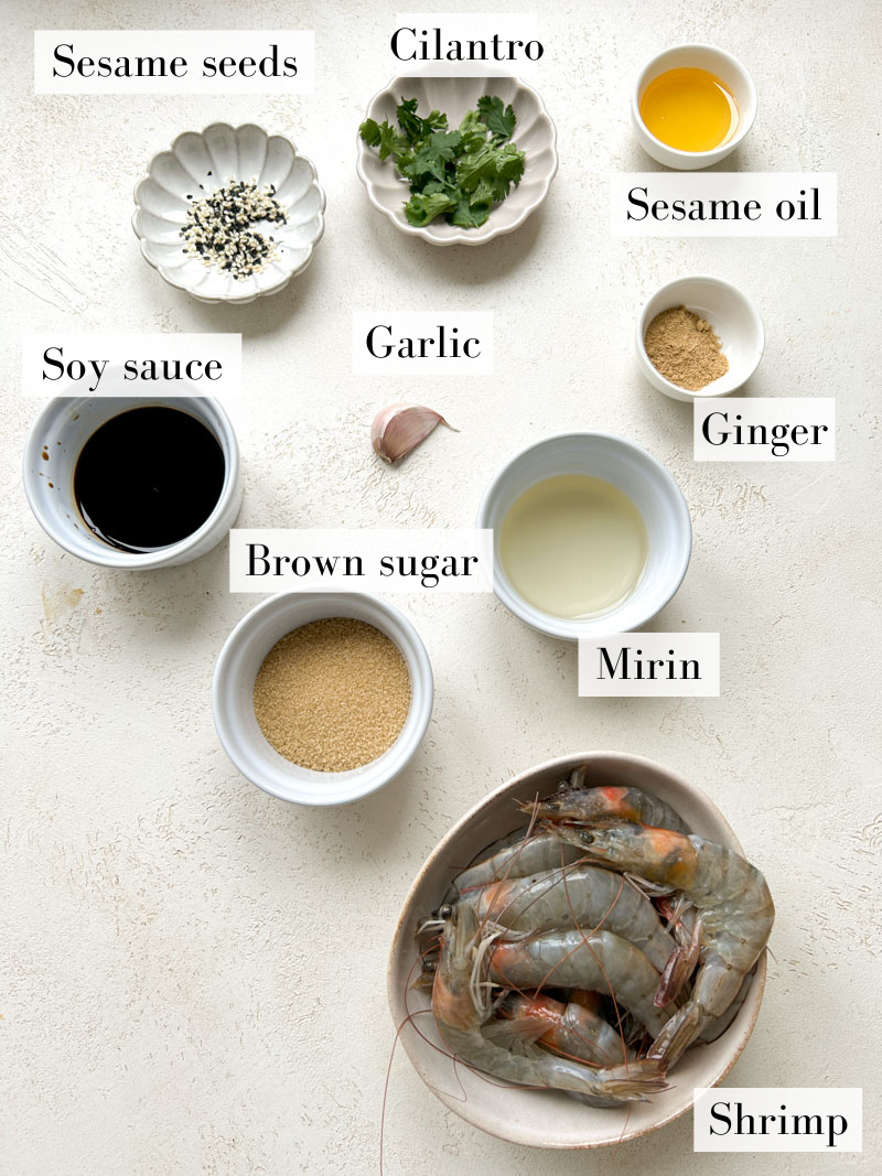 Ingredients to make Teriyaki shrimp in beige and white bowls and plates.