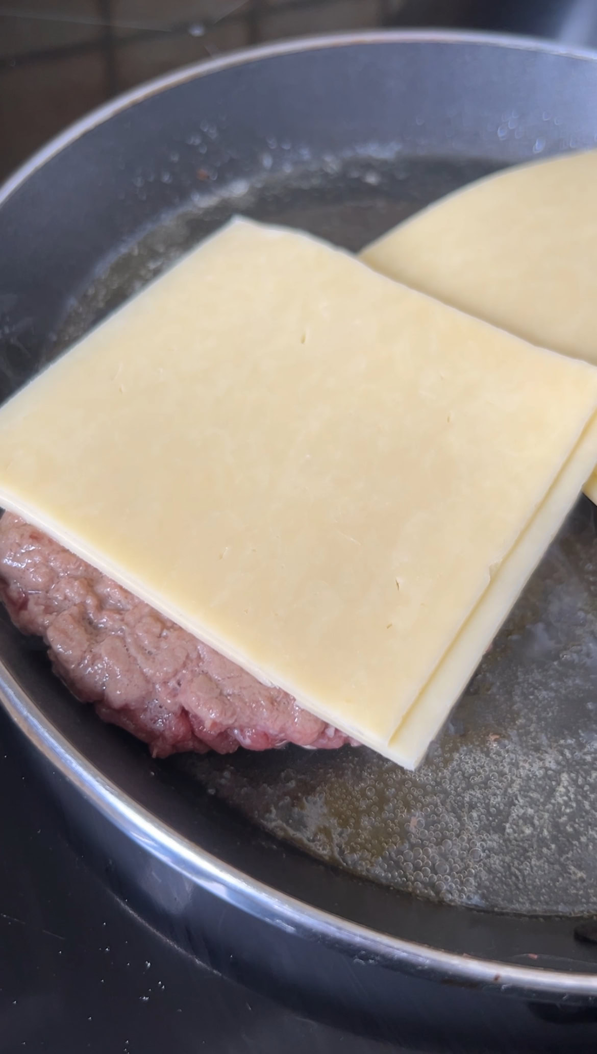 Two slices of cheddar cheese on top of the minced meat.