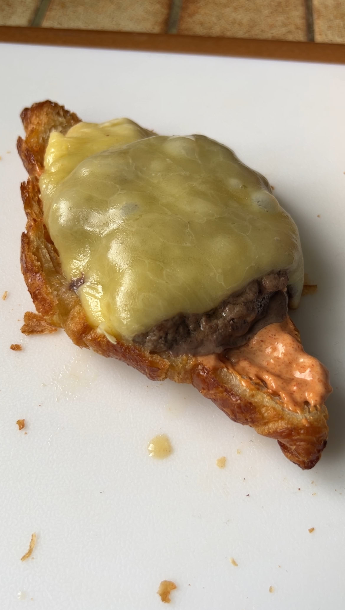 Meat covered with melted cheese added to the sauce, on the half croissant.