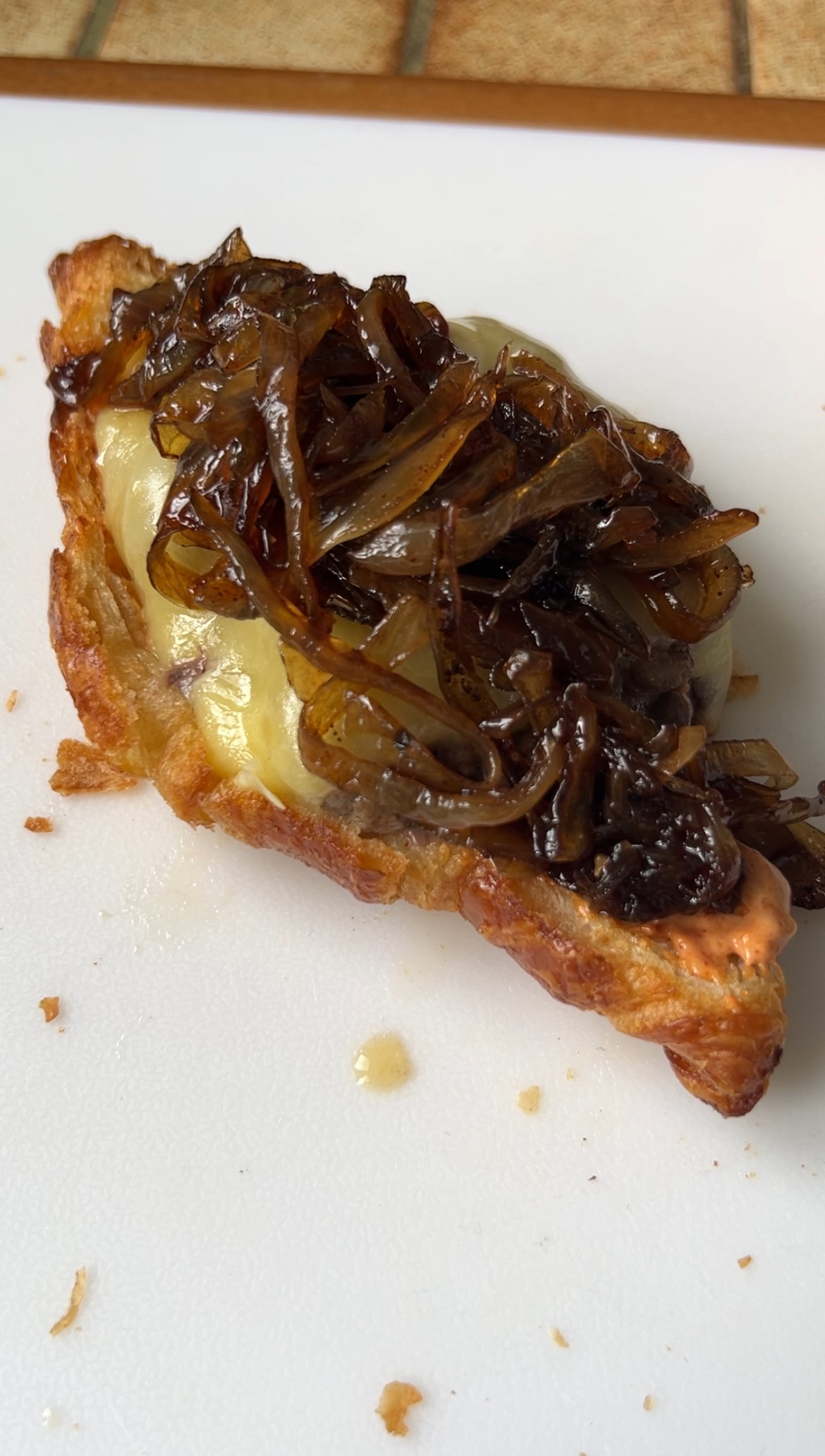Onion confit added to the meat and melted cheese, on the half croissant.