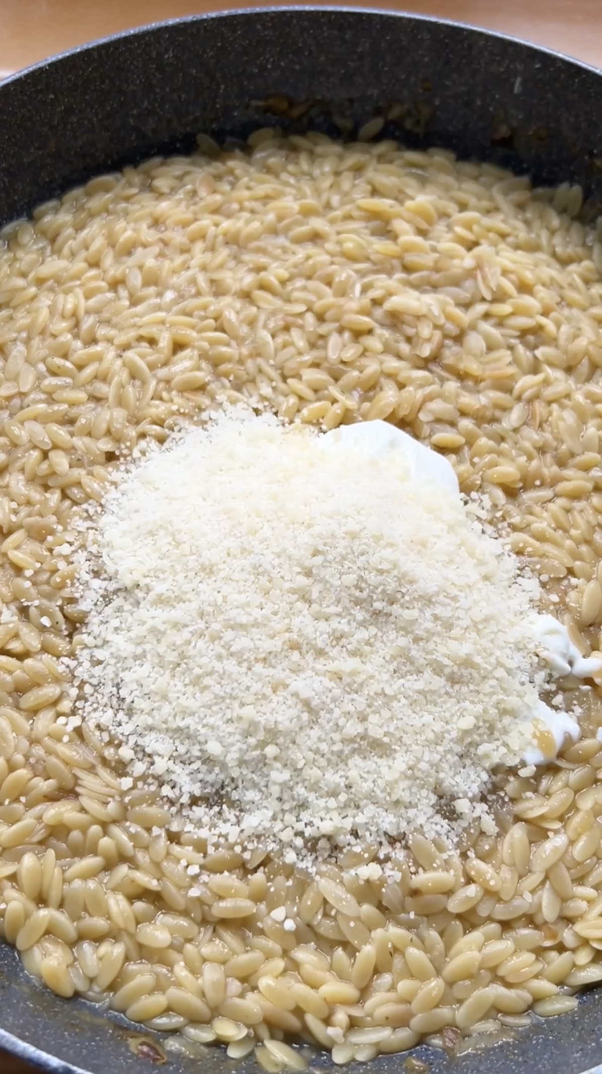 Parmesan and cream added to the pan of cooked pasta.