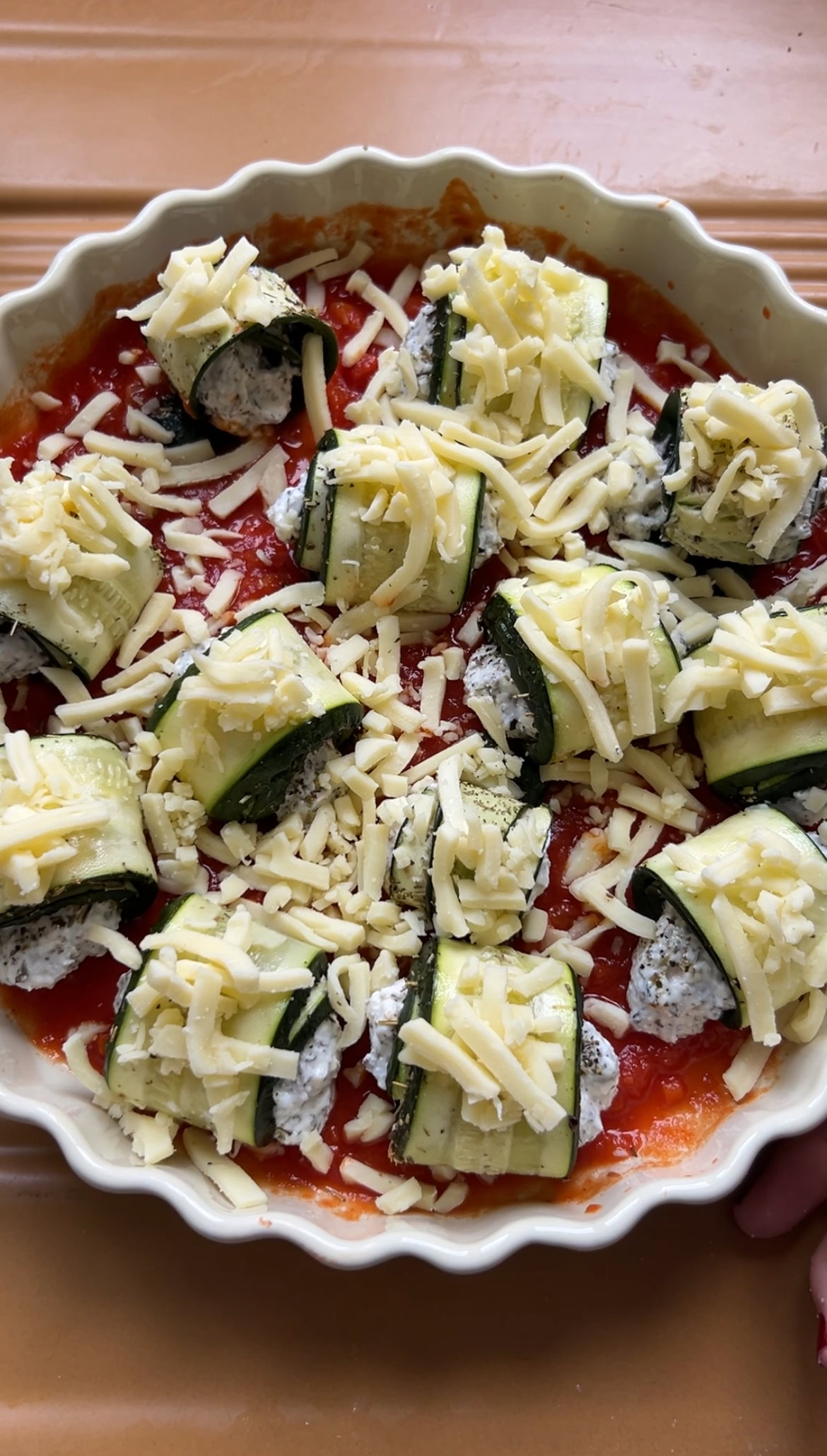 Grated mozzarella is added to the top of each involtini.