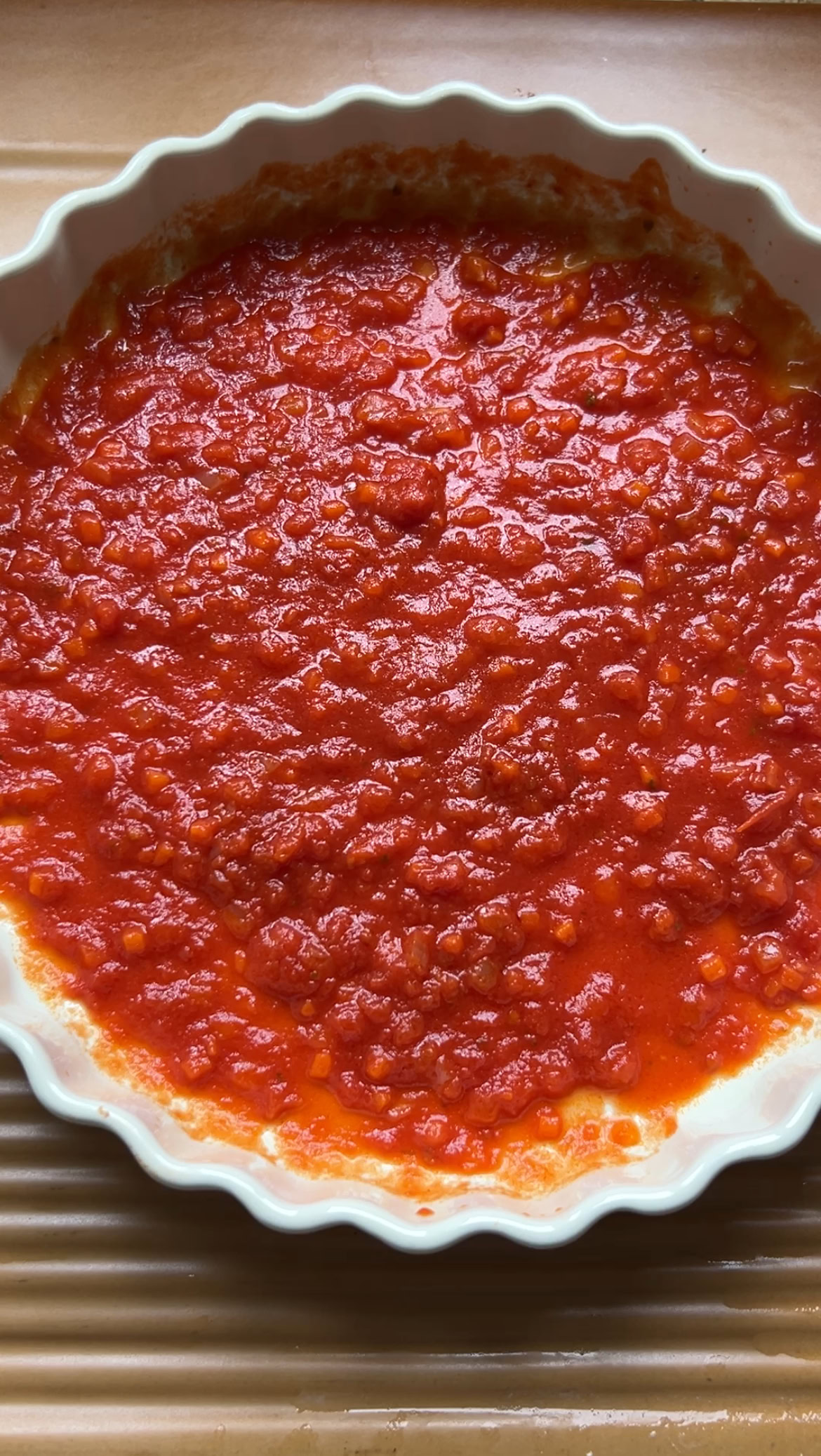 Tomato sauce in a large round dish.