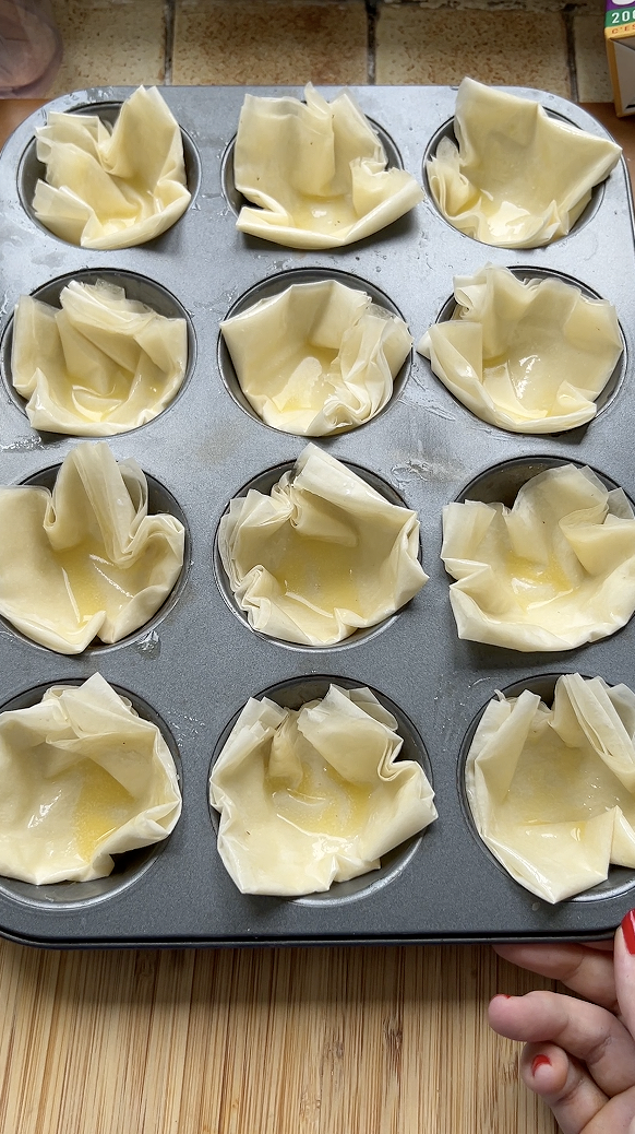 Small cups in muffin tins before baking.