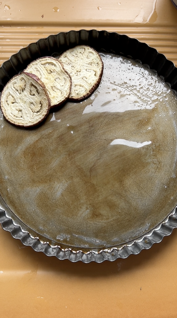 Eggplant slices are added to the removable tart tin.