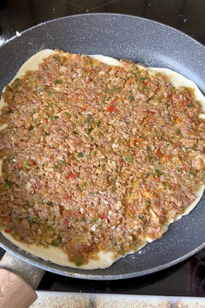 Lahmacun cooking in the pan.