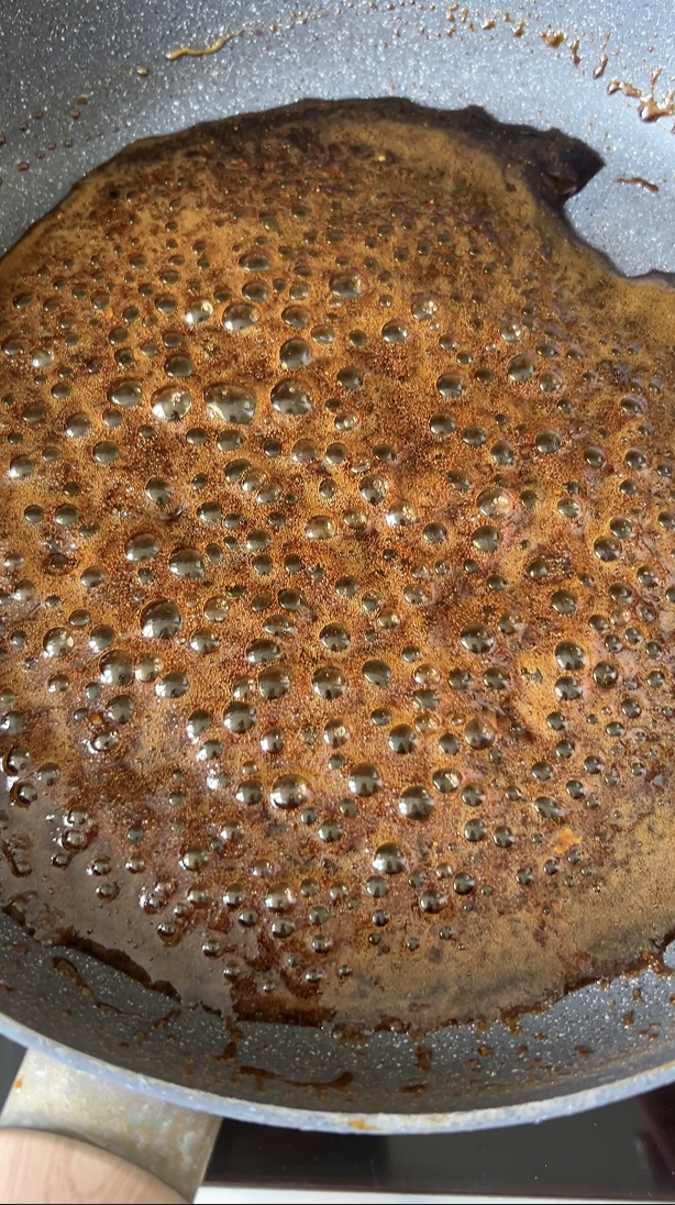 Homemade teriyaki sauce in the large pan, reducing.