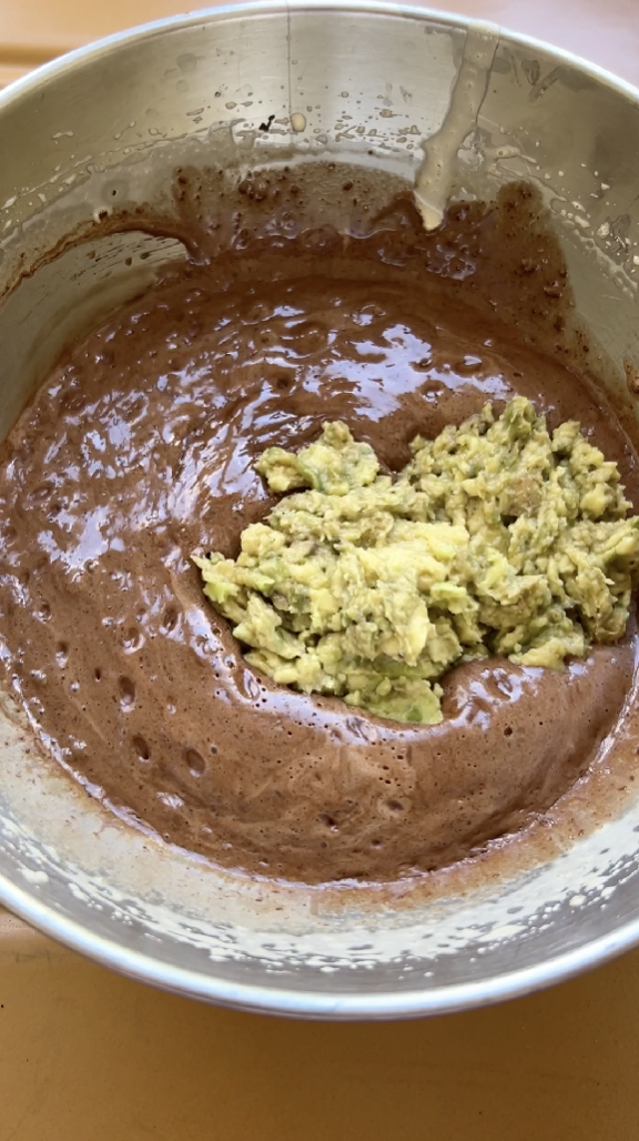 Avocado flesh added to the bowl of chocolate mixture.