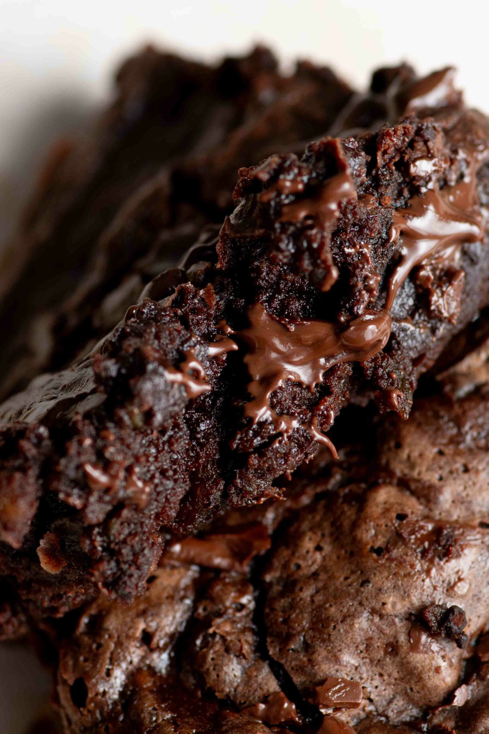 Slice of fudgy brownie with melted chocolate.