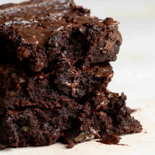 Three slices of brownie stacked on top of each other.