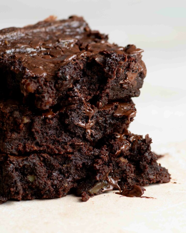 Three slices of brownie stacked on top of each other.