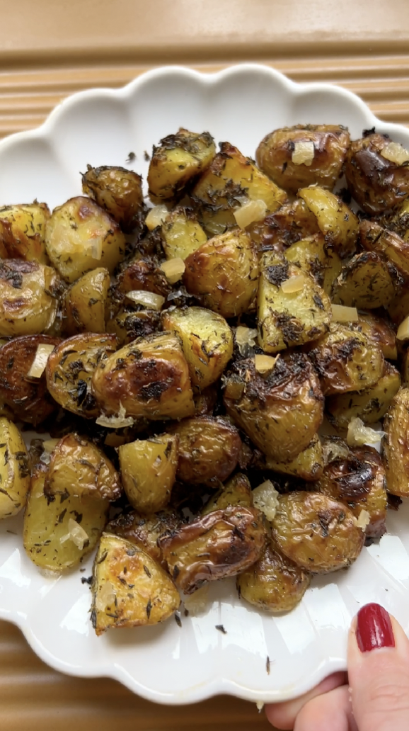 Seasoned potatoes on a plate after baking.