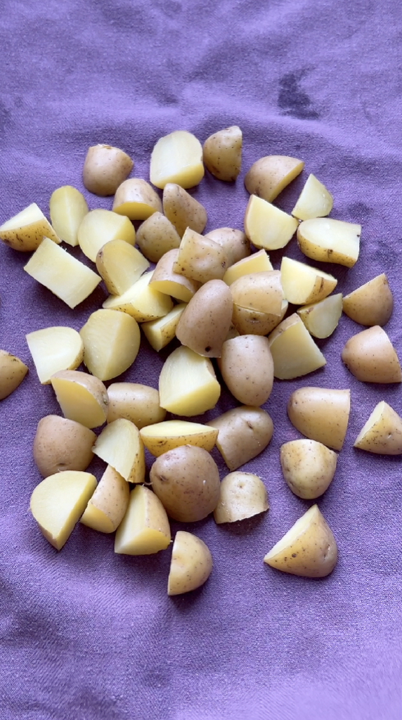 Cut potatoes on a clean purple kitchen towel.