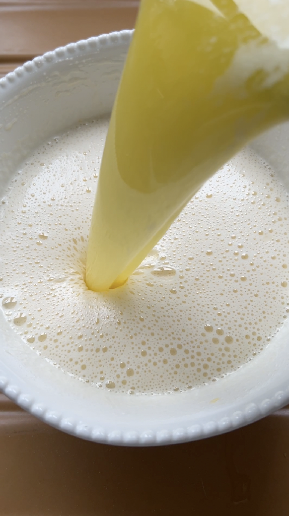 Butter poured into egg and sugar mixture.