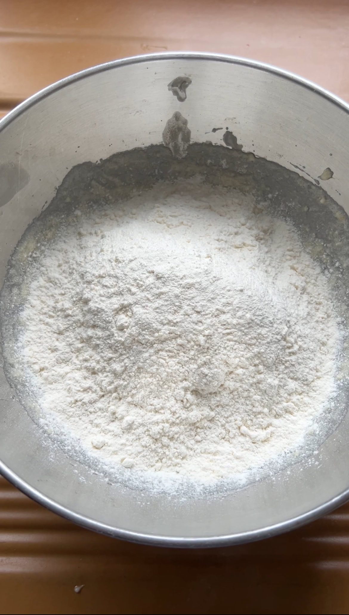 Flour added to the aluminium bowl.