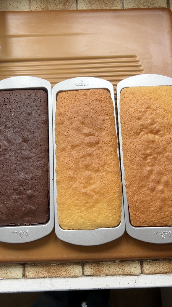 The three sponge cakes in their moulds, after baking.