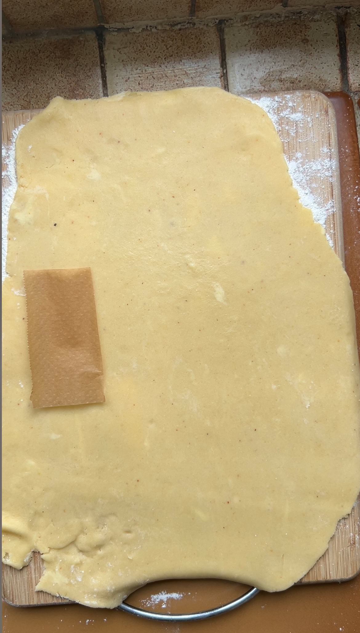 Parchment paper rectangle on the rolled-out dough.