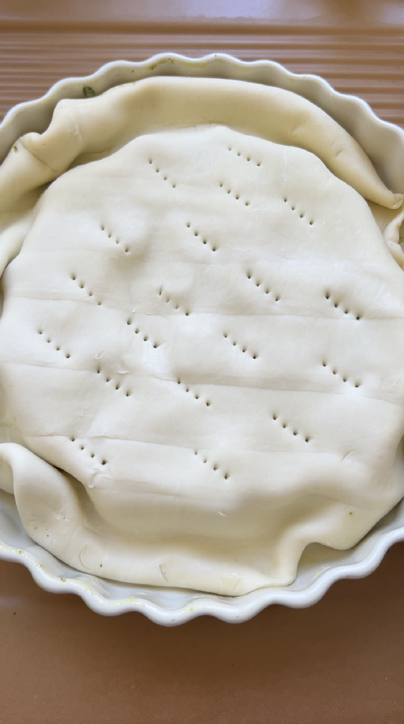 Tarte Tatin in a white dish, before baking.