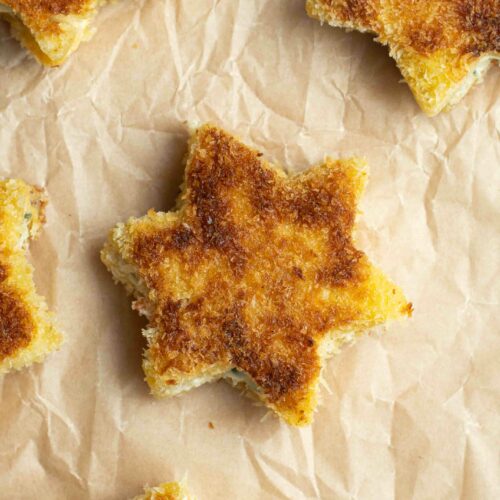 Petits croque-monsieur étoile sur du papier cuisson.